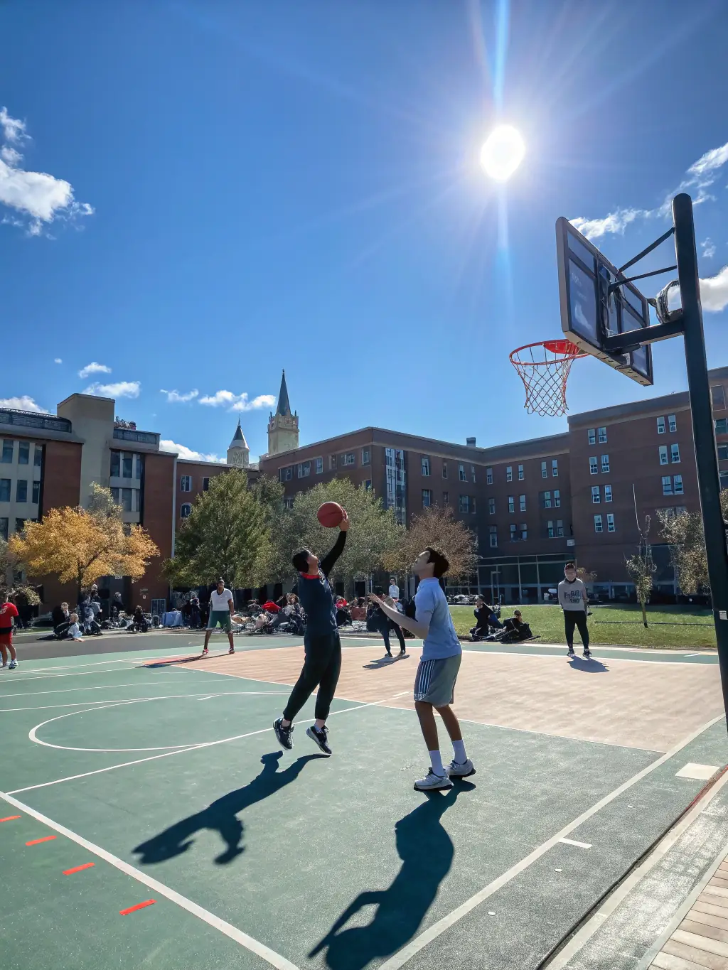 A group of students laughing and playing basketball together during a UNSS after-school program, showcasing the fun and social aspects of the sport.